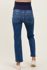 woman wearing a pair of dark blue maternity jeans with a stretchy waistband, shown from the back