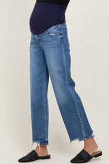 woman wearing blue distressed maternity jeans with a black belly panel and frayed hem