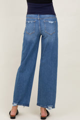 woman wearing a pair of distressed blue maternity wide-leg jeans, showing the back view with a relaxed fit