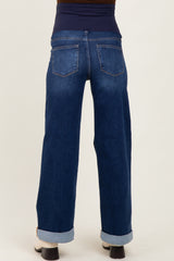 woman wearing dark blue maternity wide-leg jeans with a stretchy waistband and rolled cuffs from the back