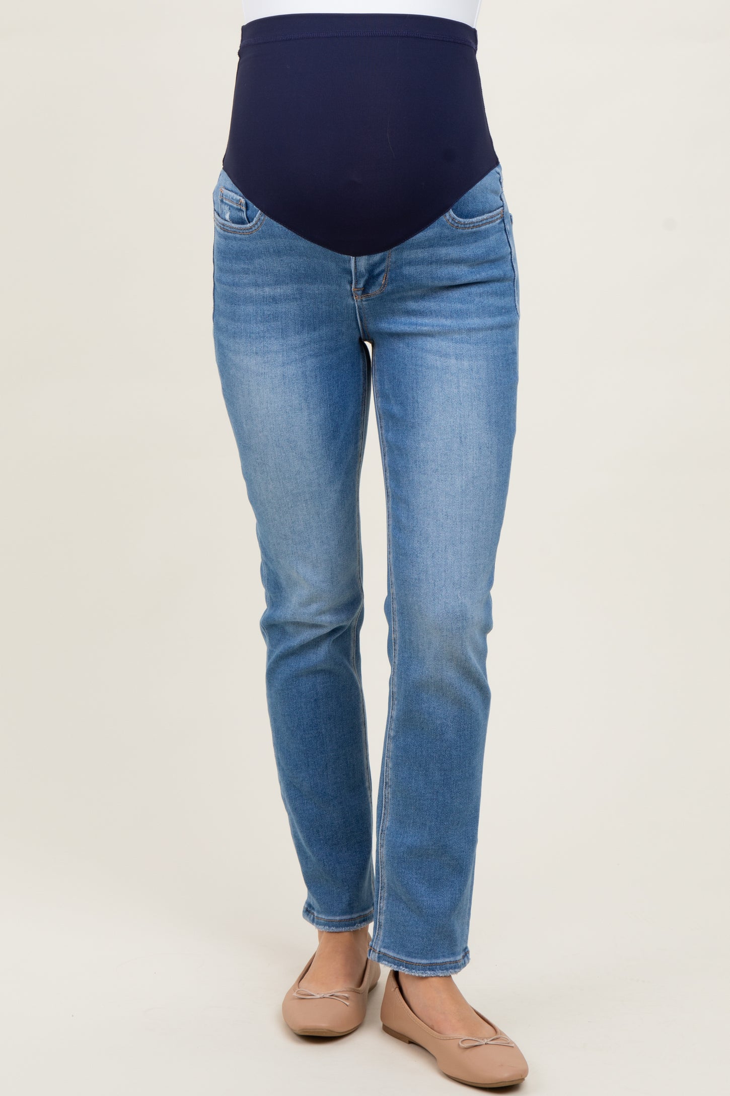 woman wearing light blue maternity jeans with a dark blue over-the-belly panel