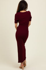 woman wearing a burgundy ribbed maxi dress with short sleeves, viewed from the back
