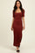 woman wearing a ribbed rust maxi dress with a square neckline and short sleeves, featuring a side slit