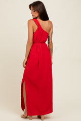 woman wearing a red maxi dress with an asymmetrical neckline and side slit, shown from the back