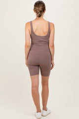 woman wearing a brown ribbed maternity romper with a fitted style and shorts, viewed from the back