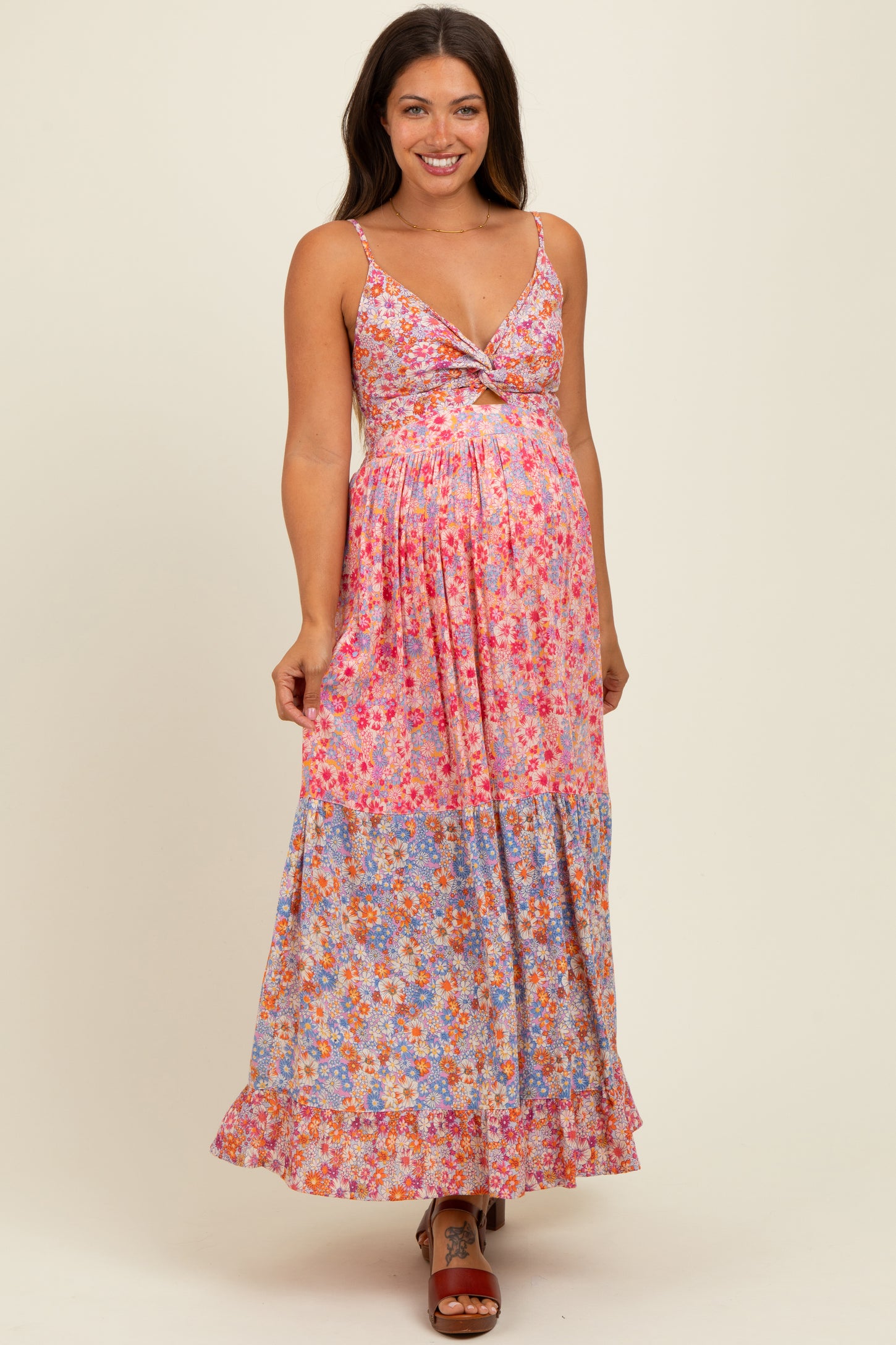 woman wearing a floral maxi maternity dress with a tie front and a visible baby bump