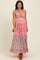 woman wearing a floral maxi maternity dress with a tie front and a visible baby bump