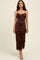 woman wearing a black floral midi dress with ruched detailing and thin straps