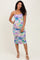 woman wearing a purple and green floral maternity dress with ruched sides and a visible baby bump