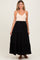 woman wearing a beige maternity tank top and a black tiered maxi skirt with a drawstring waist