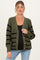 woman wearing a green and black striped maternity cardigan with buttons, showing her baby bump