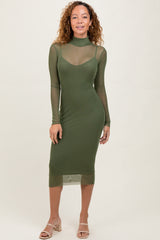 woman wearing an olive green long sleeve mesh panel midi dress with a fitted silhouette and high neckline