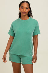 woman wearing a green striped matching short sleeve top and shorts set