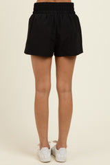 woman wearing black elastic waistband shorts, shown from the back