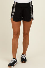 woman wearing black maternity athletic shorts with white stripes and a comfortable elastic waistband