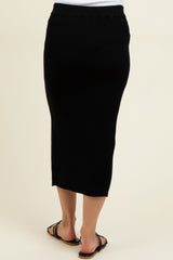 woman wearing a black ribbed maternity midi skirt, showing the back view