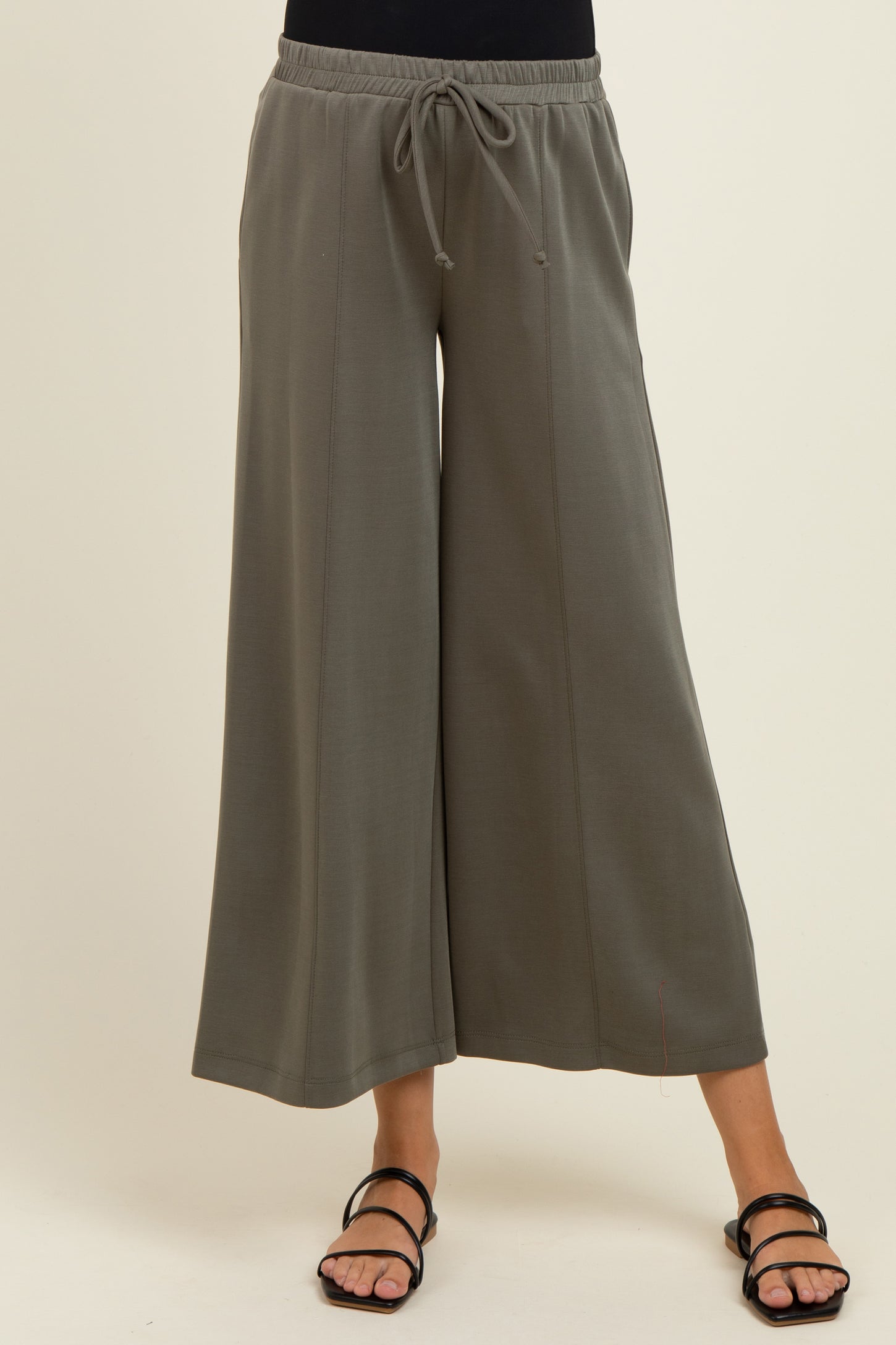 woman wearing gray wide-leg maternity pants with an elastic waistband and drawstring detail