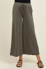 woman wearing gray wide-leg maternity pants with an elastic waistband and drawstring detail