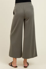 woman wearing a pair of gray wide-leg maternity pants with an elastic waistband, viewed from the back