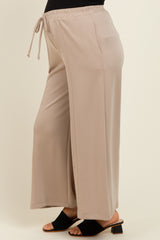 woman wearing beige maternity wide-leg pants with an elastic waistband and drawstring
