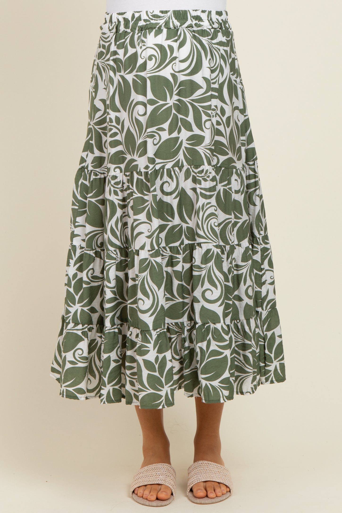 maternity wear green leaf patterned maxi skirt with tiered ruffles and an elastic waistband, model wearing sandals