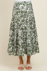 maternity wear green leaf patterned maxi skirt with tiered ruffles and an elastic waistband, model wearing sandals