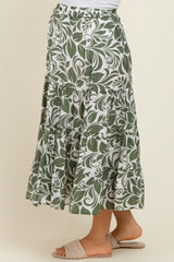 maternity wear green and white floral patterned maxi skirt with tiered design, worn by a model standing sideways