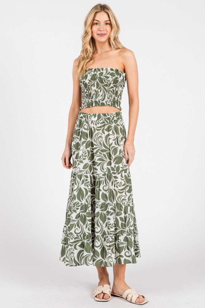 woman wearing a green and white floral print two-piece crop top and maxi skirt set