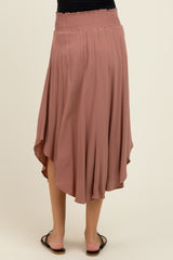 maternity wear long rose pink skirt with a smocked waistband and an asymmetrical hem, model viewed from the back