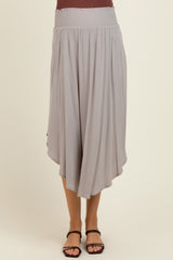 woman wearing a light gray maternity skirt with a smocked waistband and an asymmetrical hemline