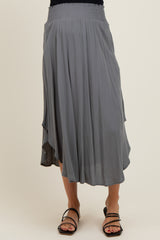 woman wearing a gray maternity skirt with a smocked waistband and flowy silhouette