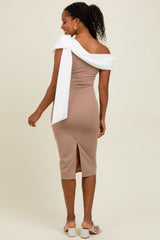 woman wearing a beige fitted midi dress with an off-the-shoulder white sash and a side slit, standing with her back to the camera