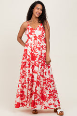 woman wearing a red and white floral maternity maxi dress with a tiered skirt and adjustable straps