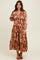 woman wearing a colorful floral print maxi dress with long sleeves and a V-neckline