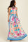 woman wearing a colorful floral maxi dress with a halter neckline and a tied waist detail