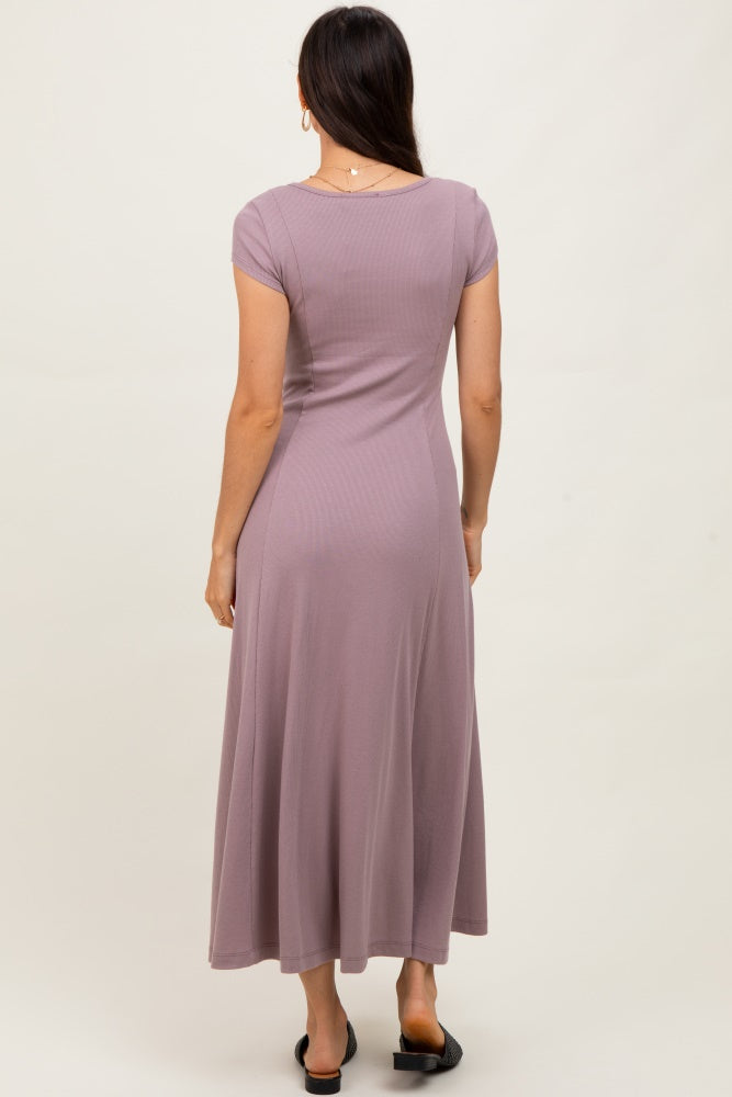 woman wearing a mauve short sleeve maxi dress, shown from the back, with a flowy skirt and fitted bodice