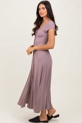 woman wearing a lavender button-up maxi dress with a fitted bodice and flowing skirt