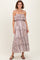 woman wearing a light purple tiered maxi dress with ruffled straps and a paisley pattern