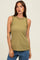 woman wearing an olive green sleeveless top with ruffle detailing along the neckline and styled with blue jeans