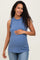 woman wearing a blue maternity tank top with ruffled neck details and holding her baby bump