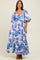 woman wearing a white floral maxi dress with puff sleeves and a square neckline