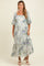 woman wearing a floral maternity maxi dress with puffed sleeves and a square neckline, showcasing her baby bump