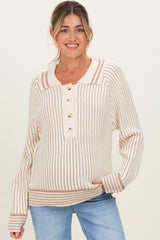 woman wearing a cream and beige striped maternity sweater with button details and relaxed fit