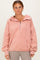 woman wearing a pink pullover hoodie with a half zipper and front pocket