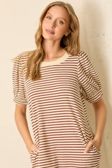 woman wearing a striped knit top with puffed short sleeves and side pockets