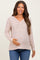 woman wearing a striped long sleeve maternity top and holding her baby bump