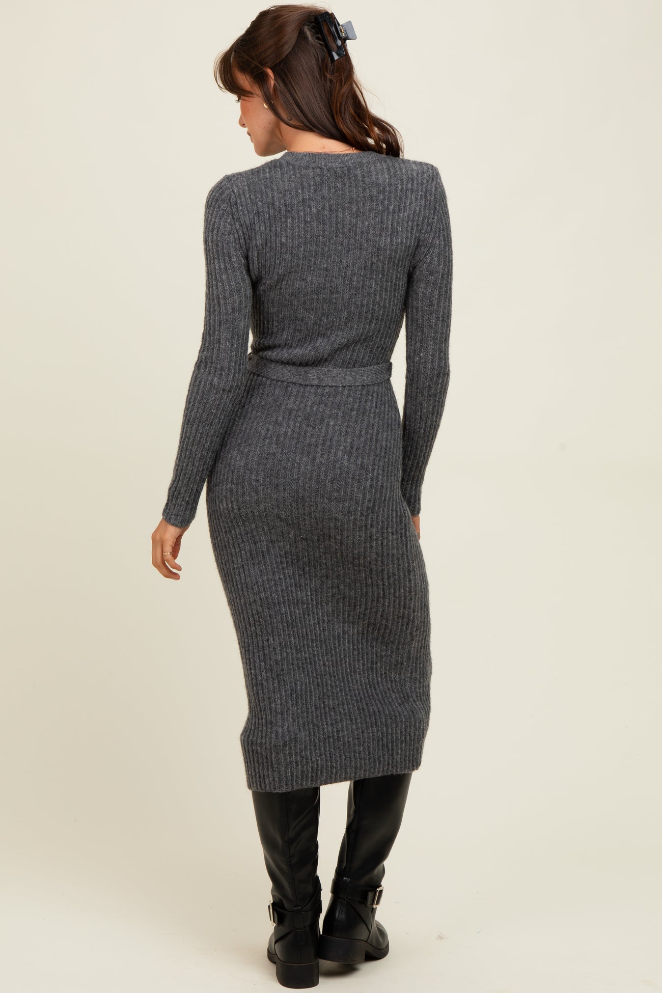 woman wearing a dark gray ribbed knit midi dress with long sleeves and a fitted silhouette, viewed from the back