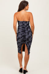 woman wearing a black and navy tie-dye strapless maternity dress with ruched detailing and a slit at the back