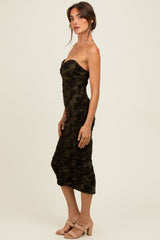 woman wearing a dark green strapless midi dress with ruching and a fitted silhouette