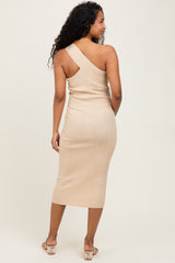 woman wearing a beige one-shoulder ribbed maternity dress, showcasing a form-fitting style and mid-calf length